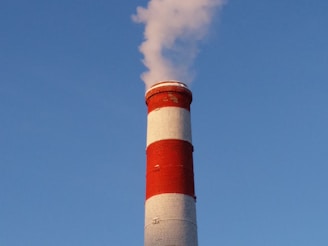 white and red concrete tower under blue sky during daytime