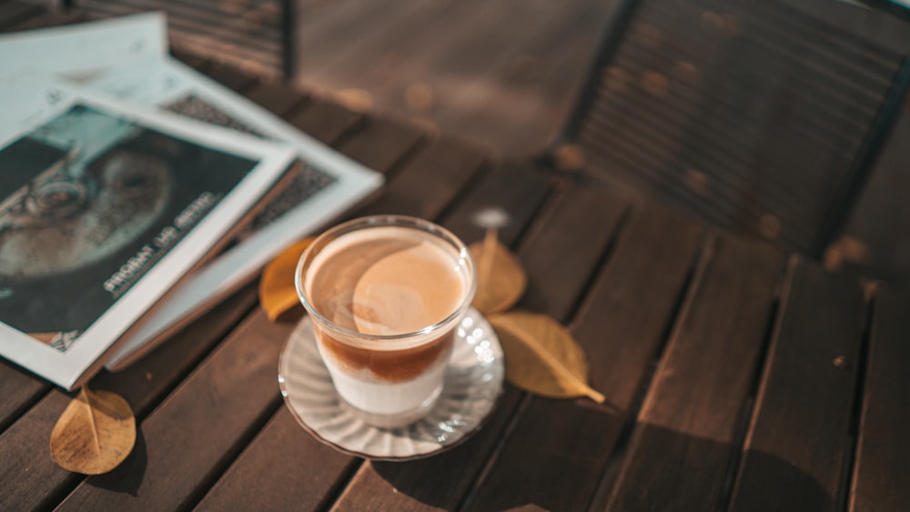 clear glass cup on saucer