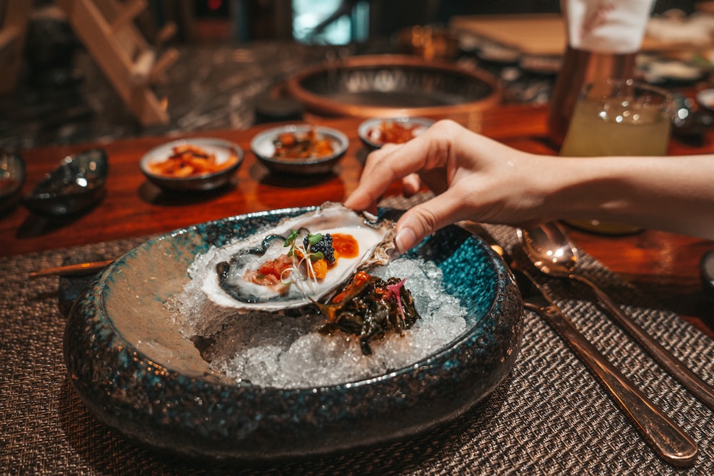 person holding white ceramic plate with food