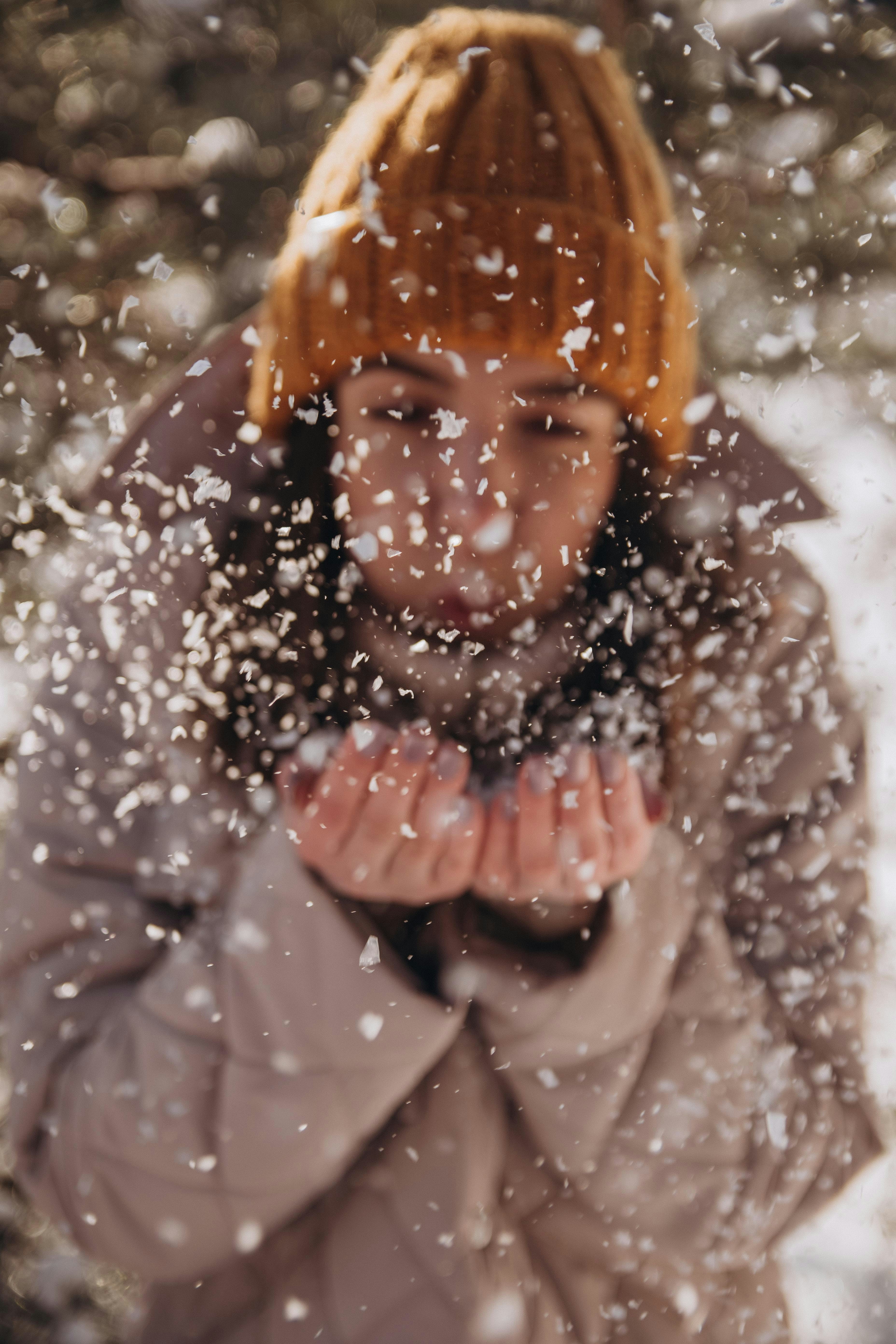 woman in gray jacket with orange knit cap