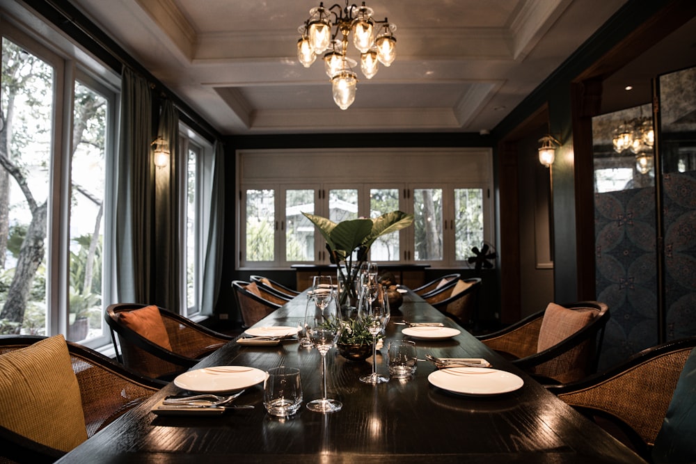 clear glass chandelier above brown wooden table