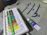 Close-up of vibrant acrylic paint tubes arranged neatly on a wooden table.