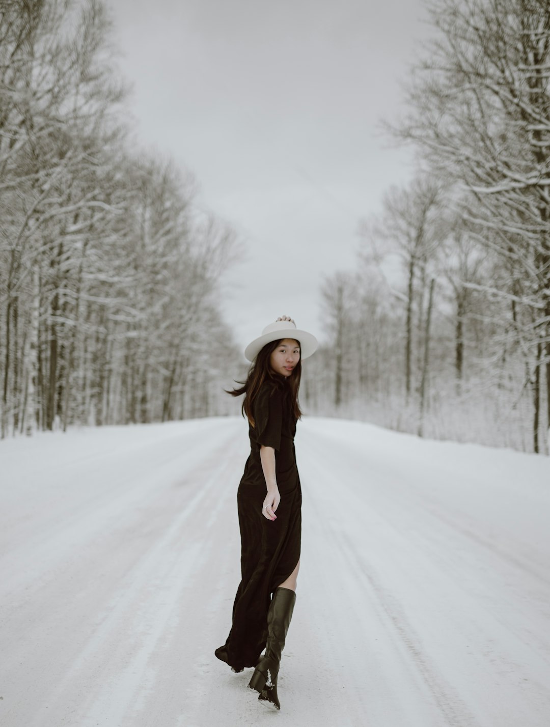 woman in brown long sleeve dress standing on snow covered ground during daytime