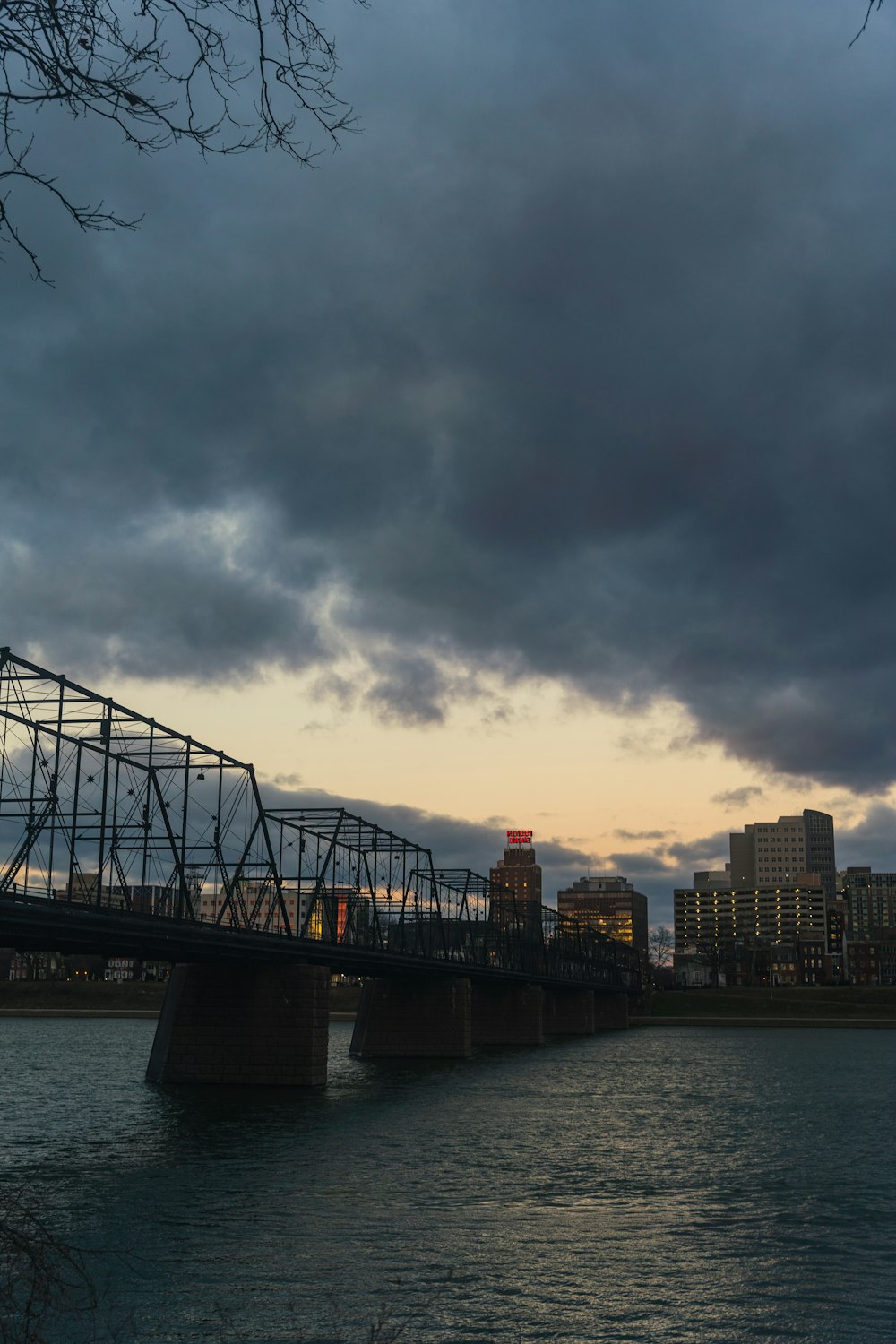 pont au-dessus de l’eau sous un ciel nuageux pendant la journée