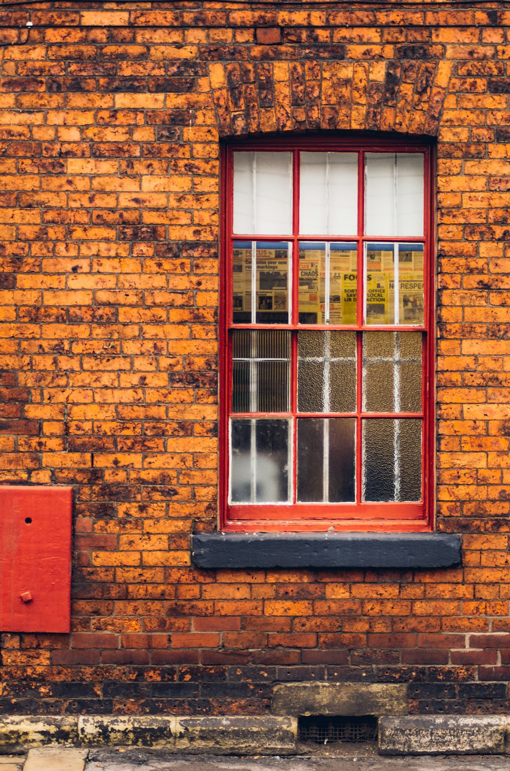 red wooden framed glass window