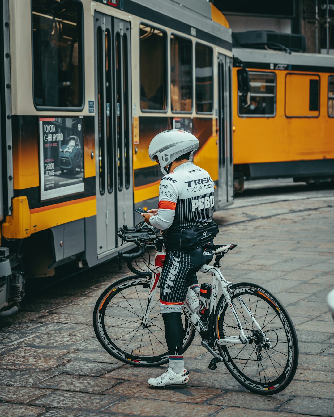man in white and black jacket riding bicycle
