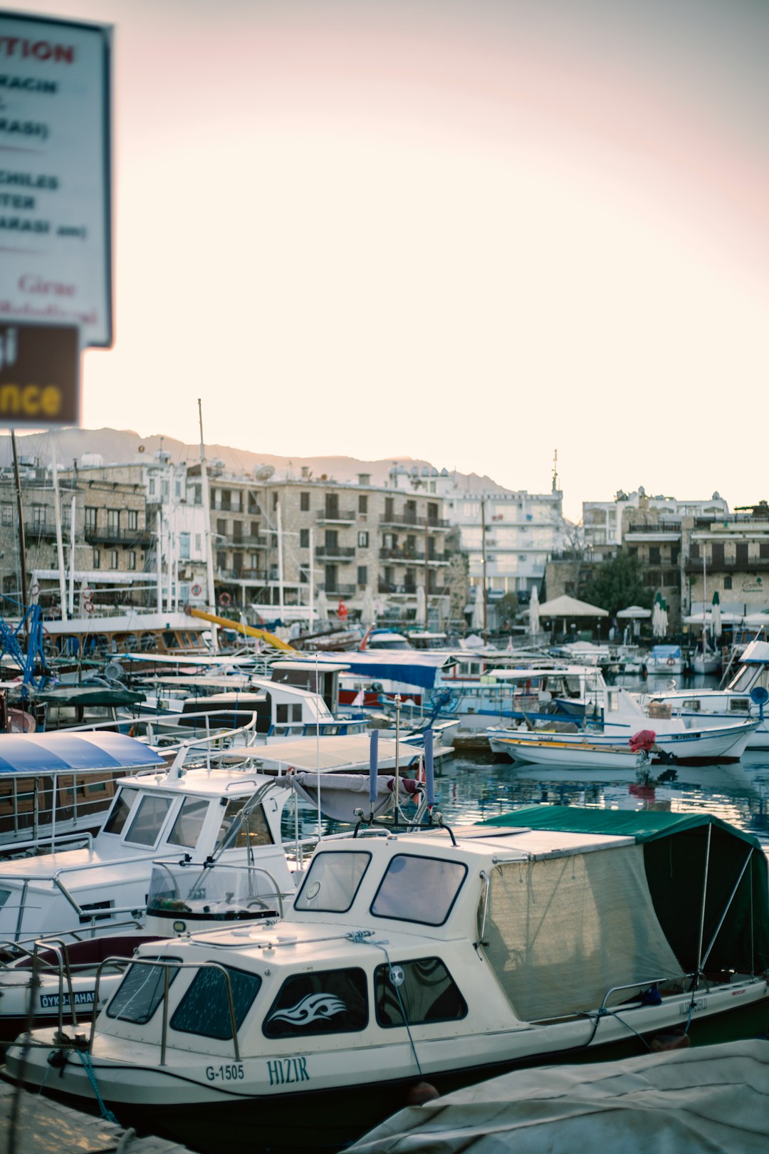 white and blue boats on dock during daytime