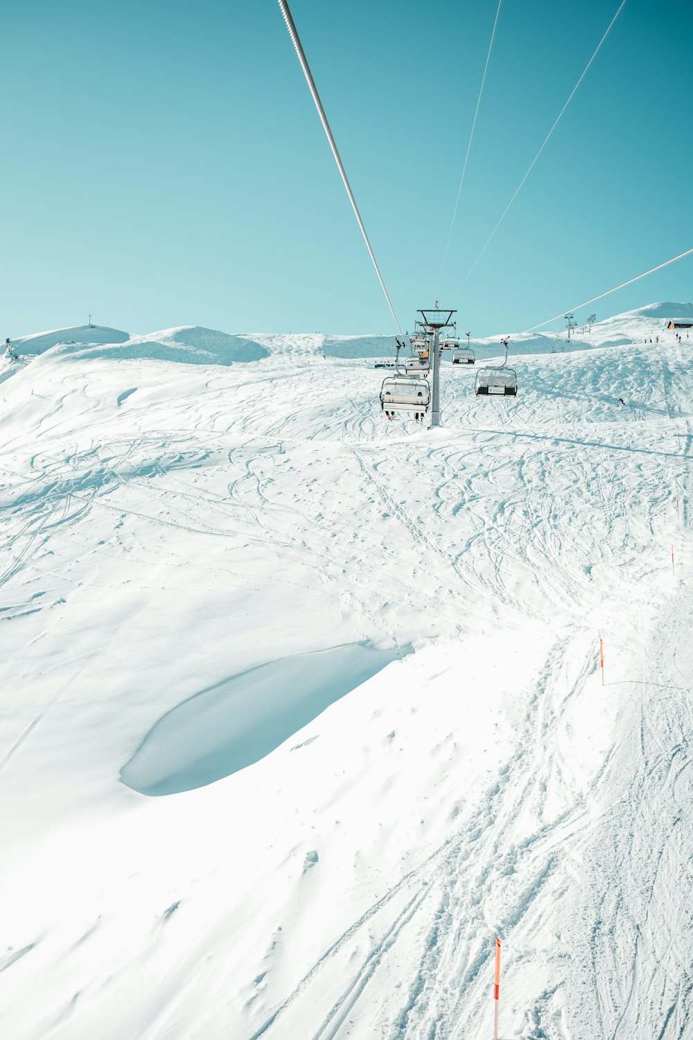 cable car over snow covered mountain during daytime