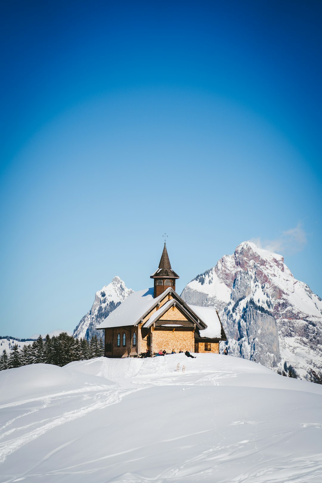 brown wooden church on snow covered ground