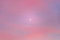 A dreamy poster with a crescent moon and mystical clouds blending into a soft white background.