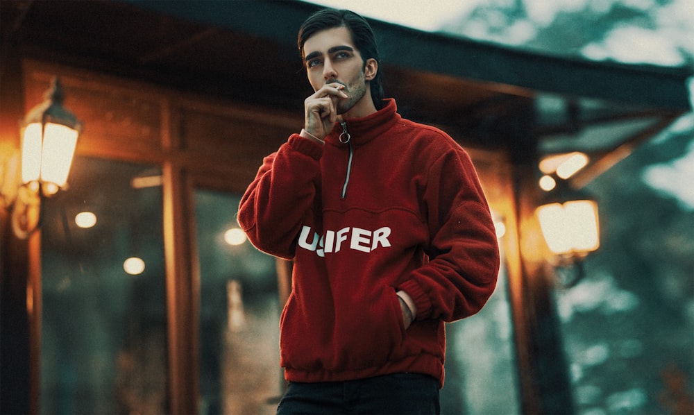 woman in red hoodie standing and smiling