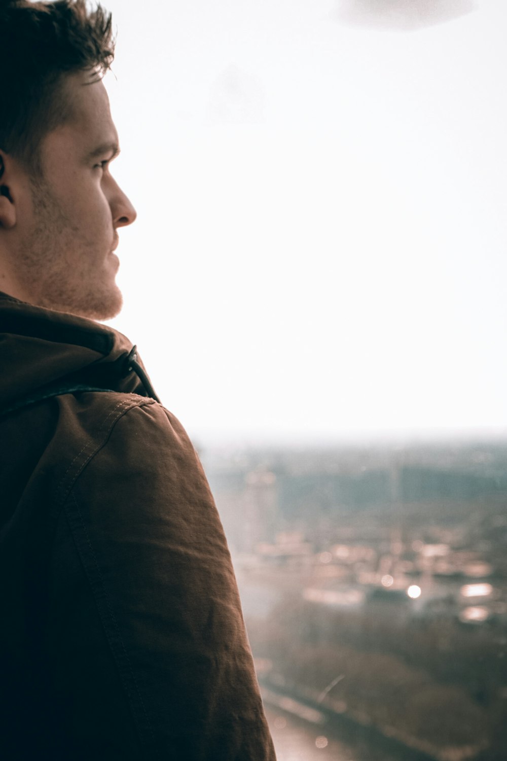 man in black jacket looking at the sky during daytime