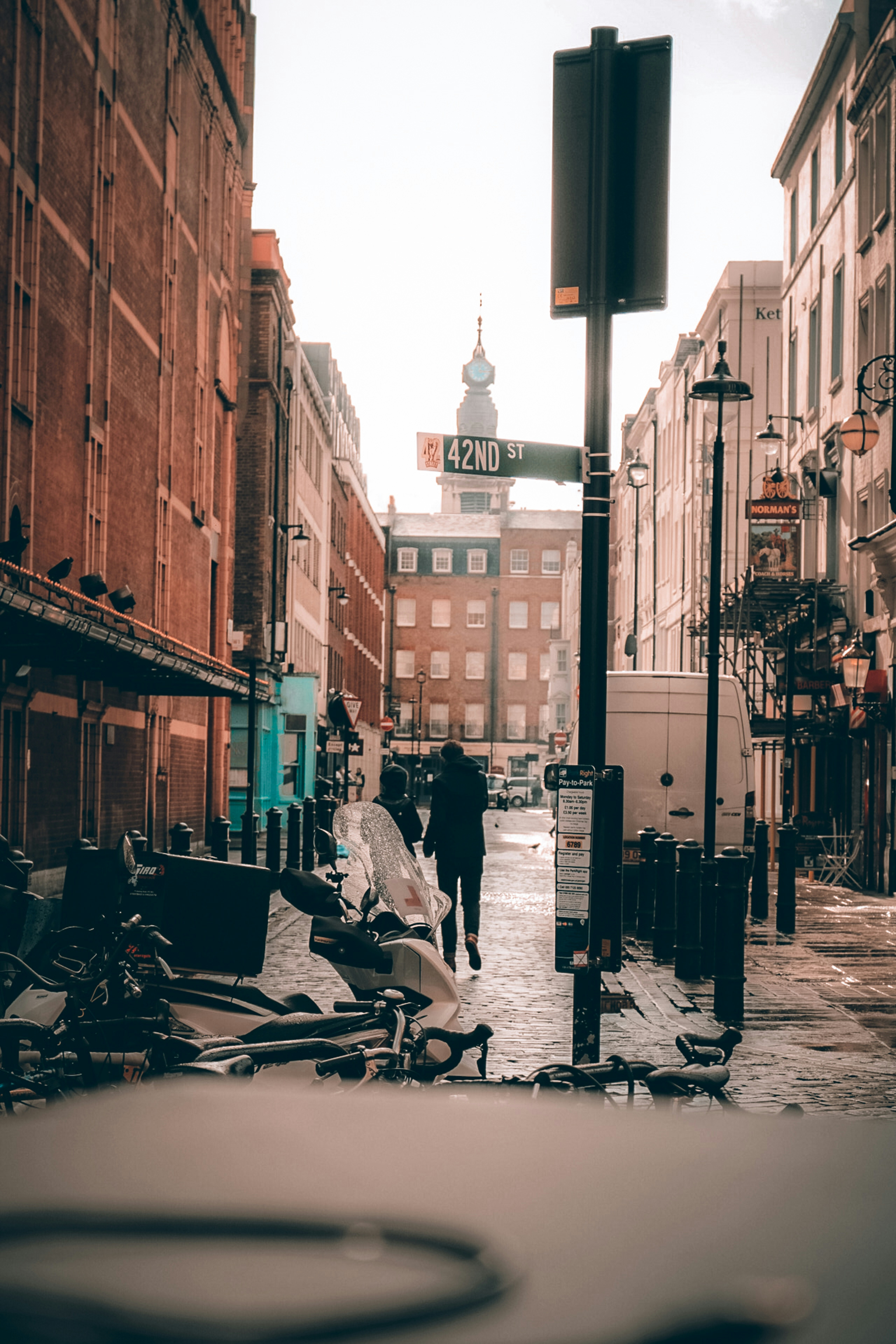 People sitting on bench near building during daytime