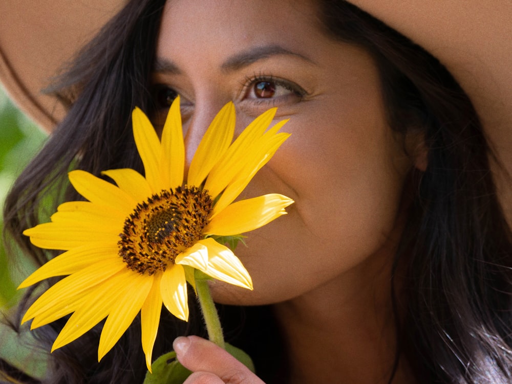 woman with yellow daisy on her ear