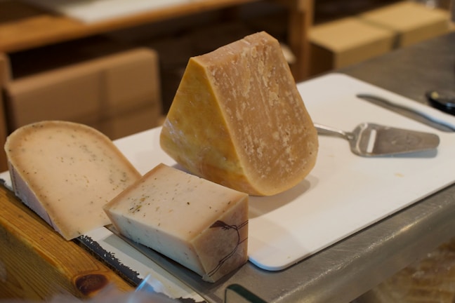 A variety of regional cheeses on a cheese board.