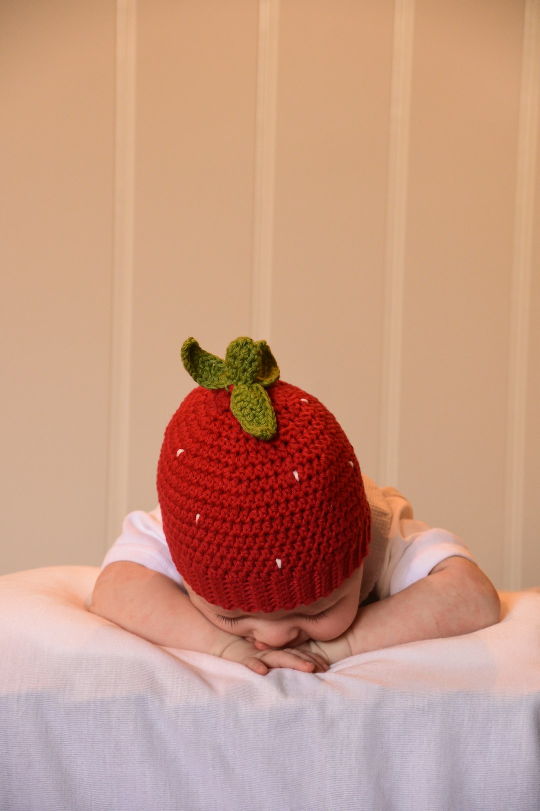 person holding red strawberry fruit