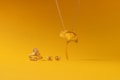 A collection of gold jewelry is set against a vibrant yellow background. The pieces include a ring, earrings, and a necklace, all designed to resemble a ginkgo leaf. The shiny metallic finish of the jewelry contrasts with the matte yellow surface.
