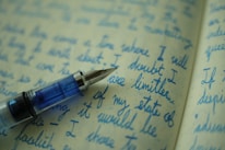 A close-up of a notebook and pen on a desk.