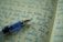 A close-up of a sleek pen resting on an open notebook.
