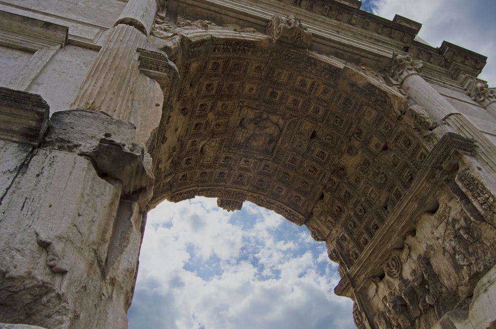 low angle photography of arch shaped concrete building