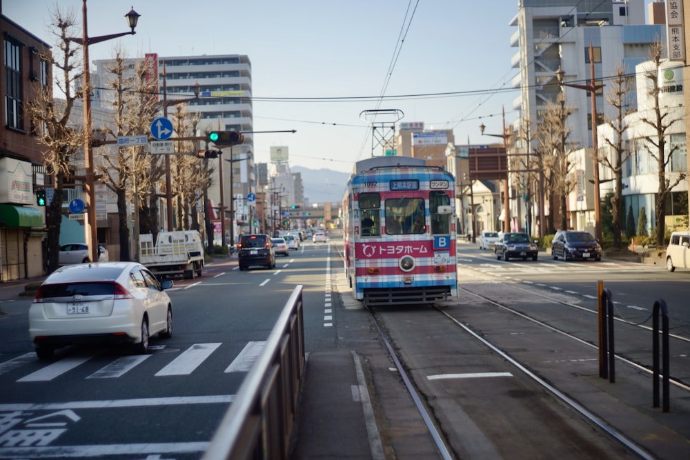 white and red tram on road during daytime