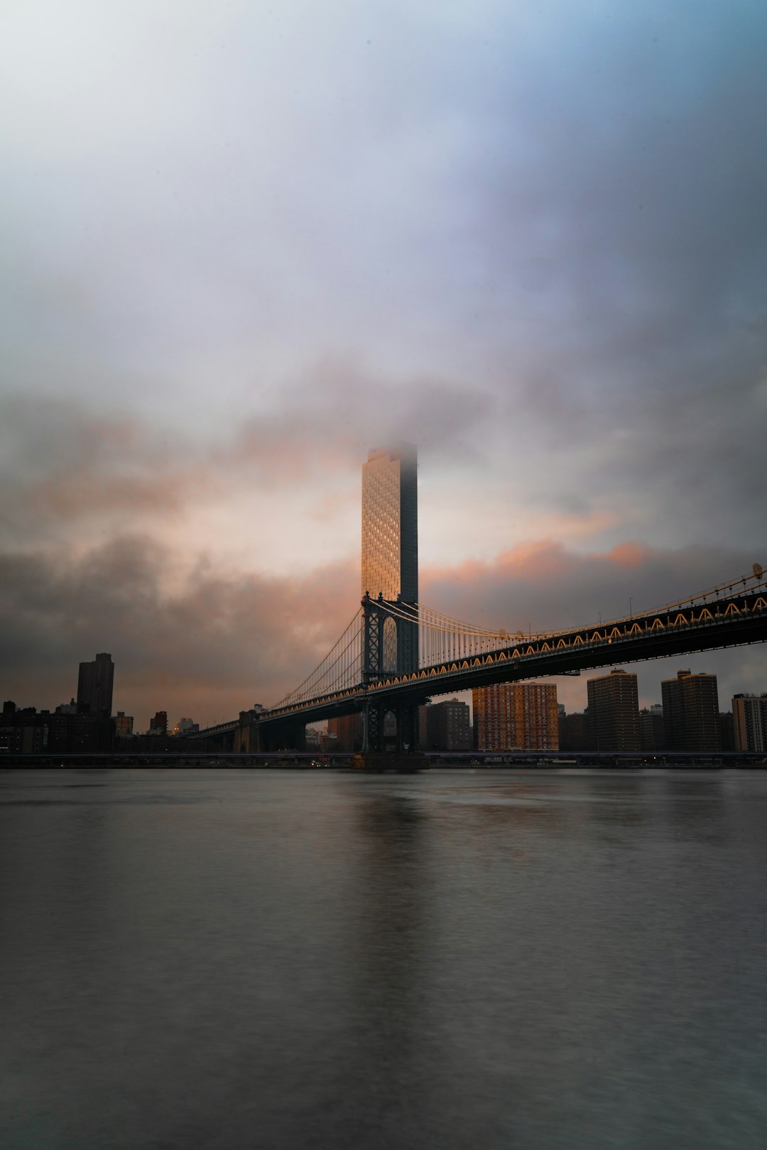brown bridge under cloudy sky during daytime