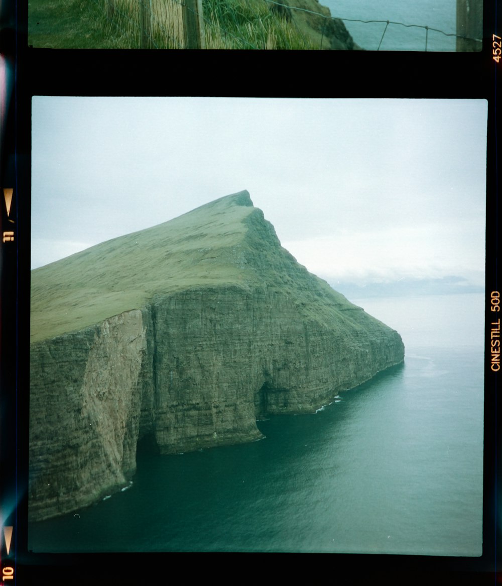 brown rock formation on body of water during daytime