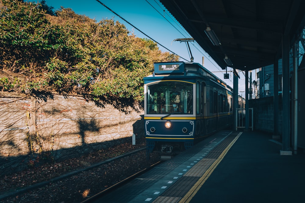 white and black train on rail tracks during daytime