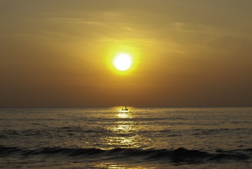Sunset view from a boat with calm sea and warm golden light over Mallorca coastline.