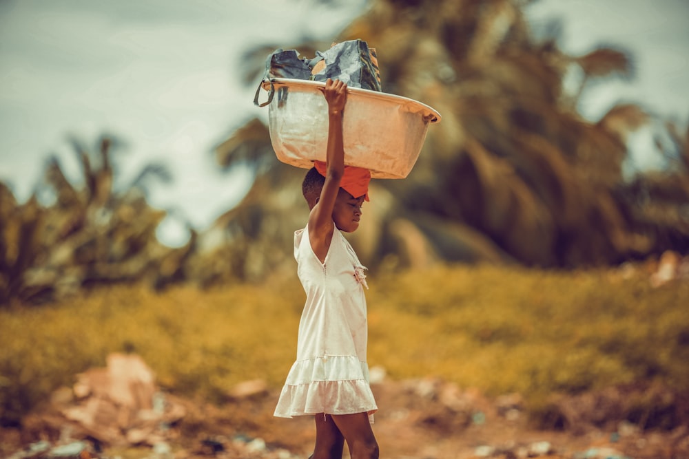 woman in white dress carrying brown leather sling bag