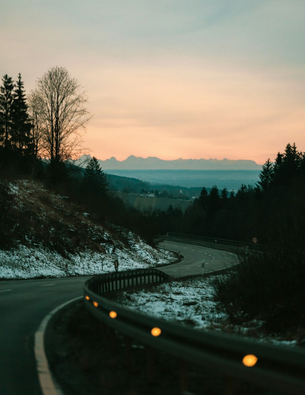 black asphalt road between trees during daytime