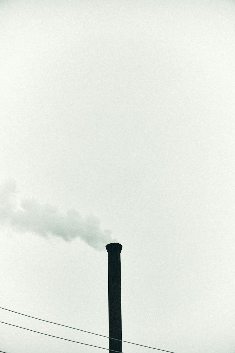 black metal pipe under white clouds