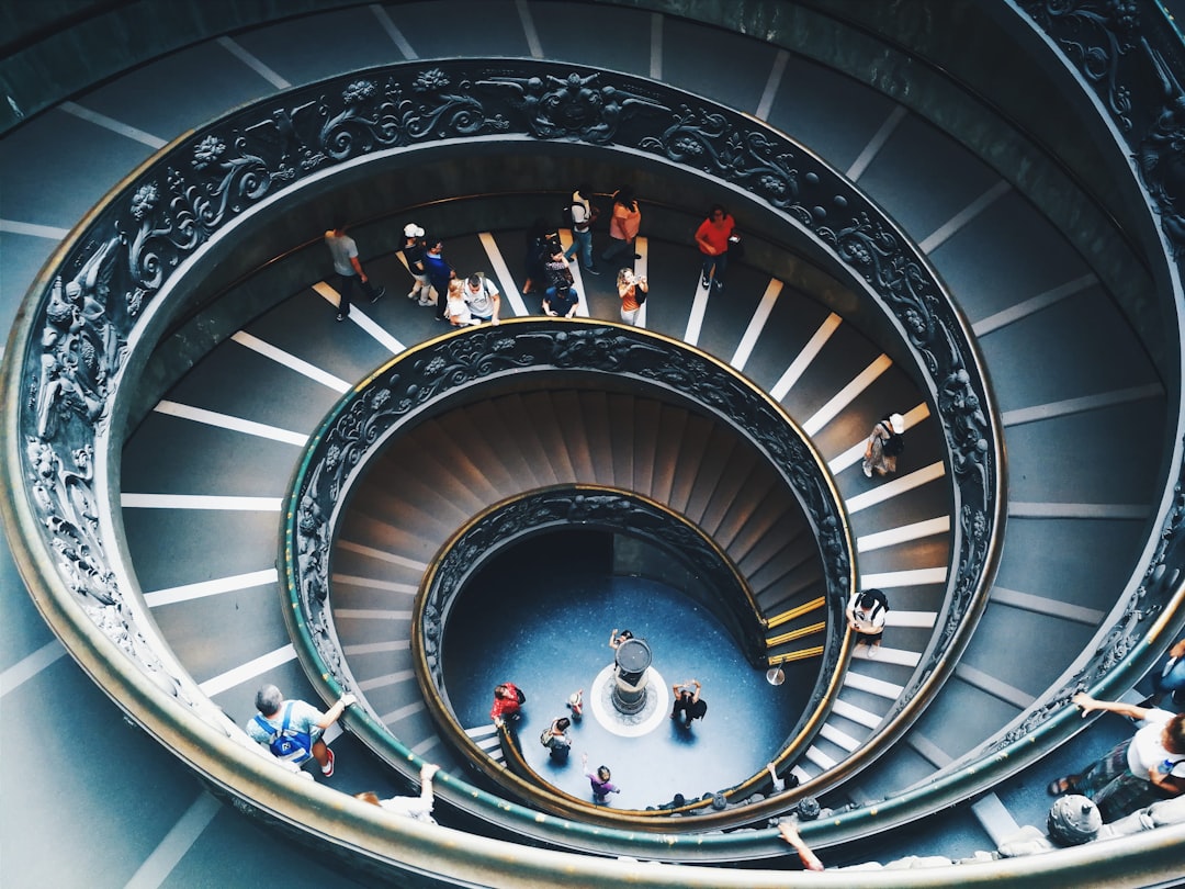 people walking on spiral staircase