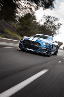 A dynamic shot of a car racing on a winding road.