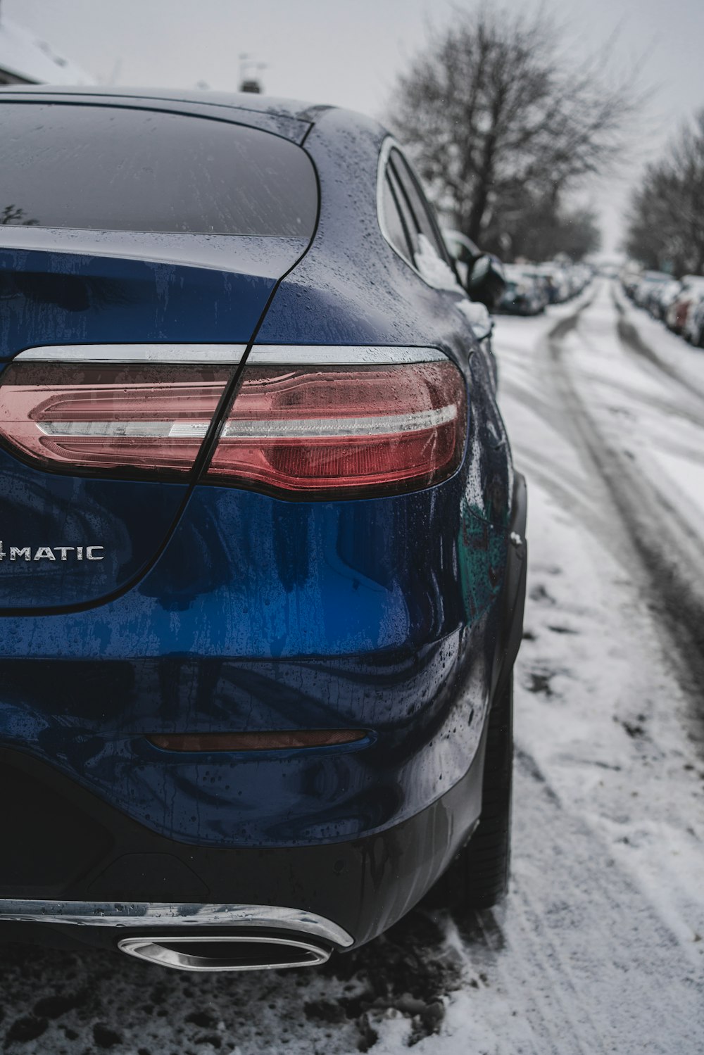 blue car on snow covered road during daytime