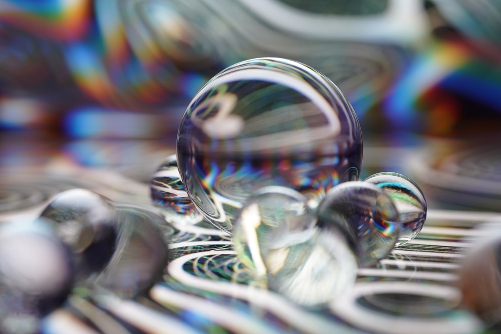 clear glass ball on white and blue textile