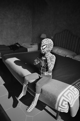 woman in black and white long sleeve shirt sitting on black couch