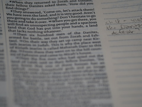 A close-up of hands flipping through a printed manuscript.