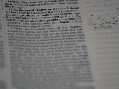 A close-up photo of an open manuscript page with neat handwritten notes in dark ink on cream paper.