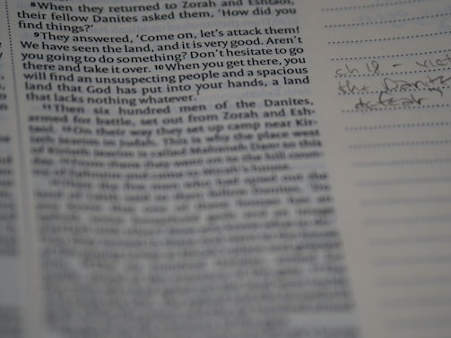 A close-up of a weathered book with eerie handwritten notes.