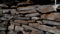 Close-up of moss-covered stones resembling the textures found in the Great Wall of China.