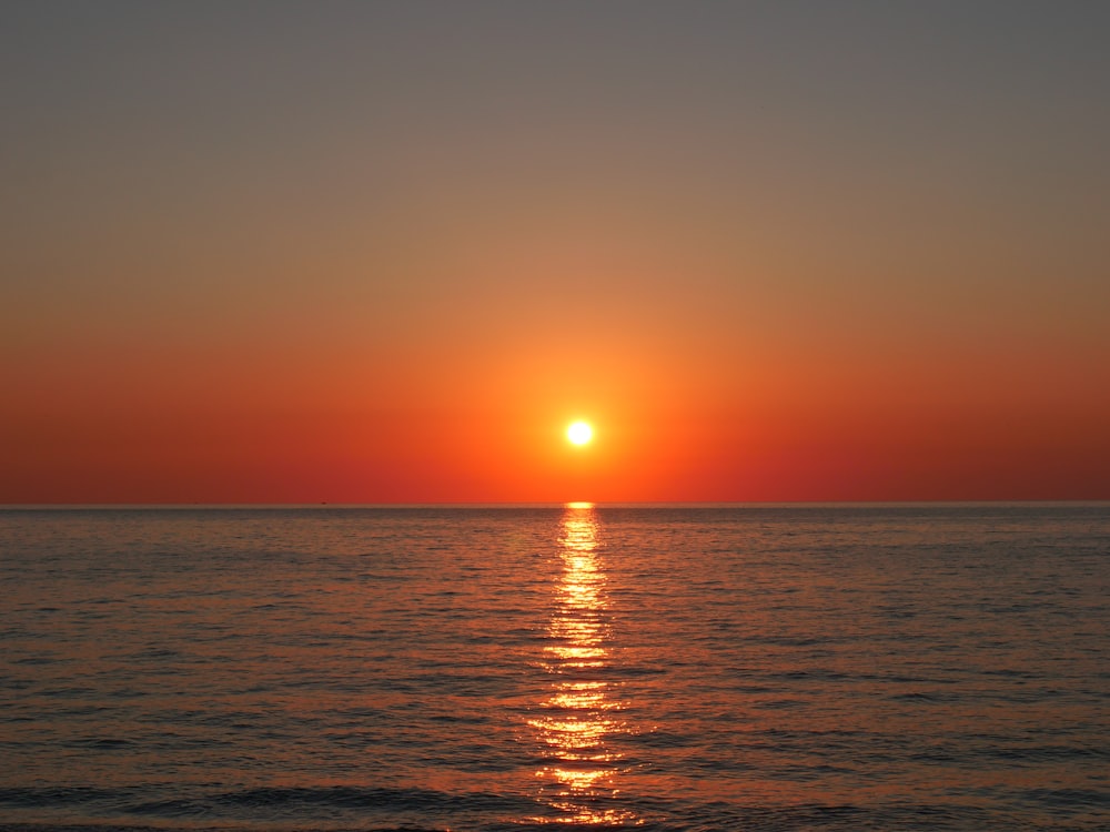 body of water during sunset