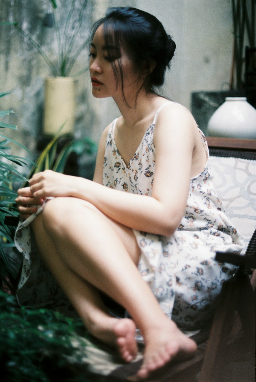 woman in white floral dress sitting on couch