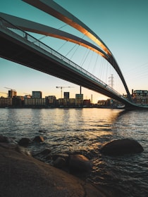 brown metal bridge over body of water during daytime