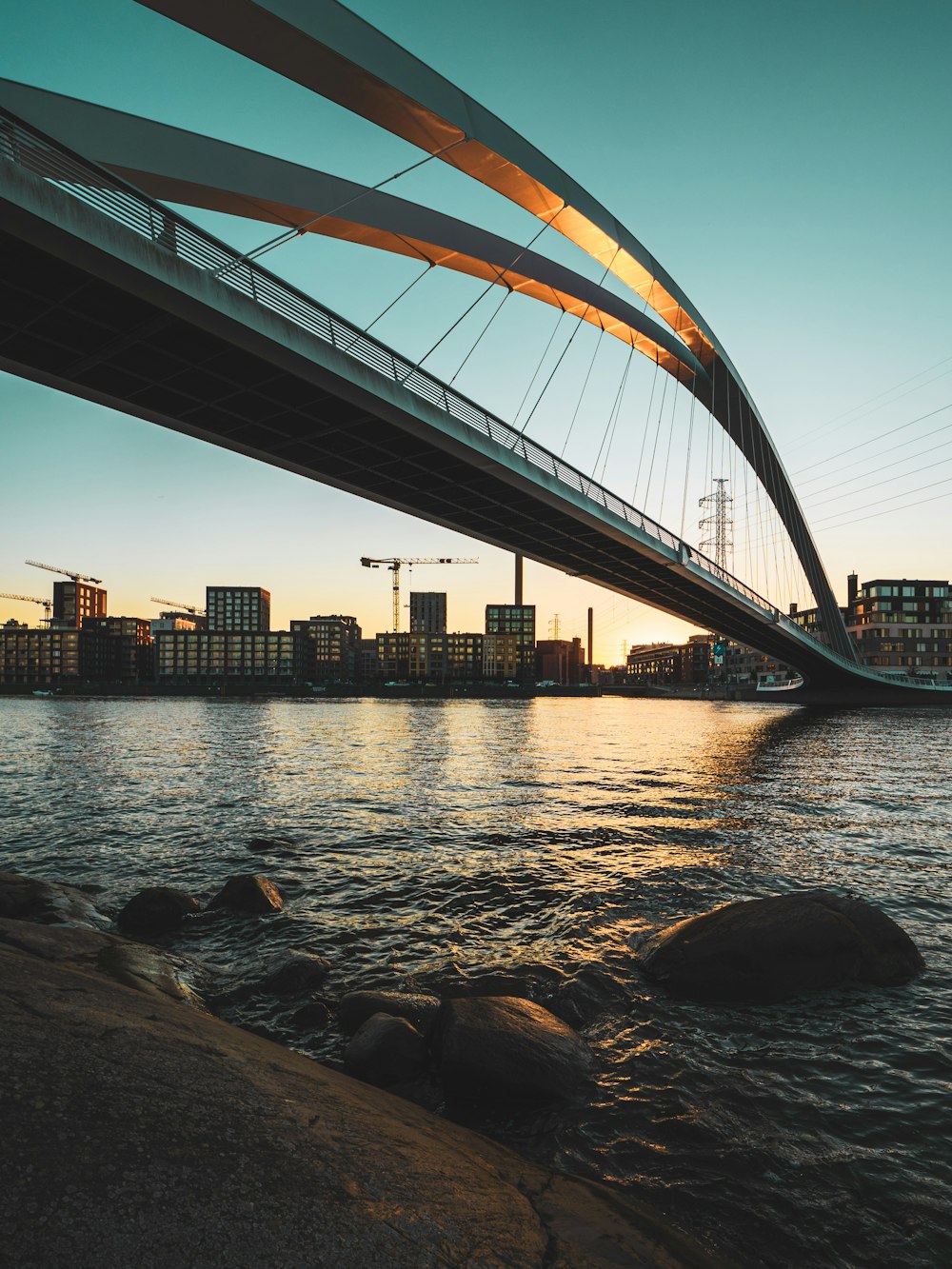 brown metal bridge over body of water during daytime