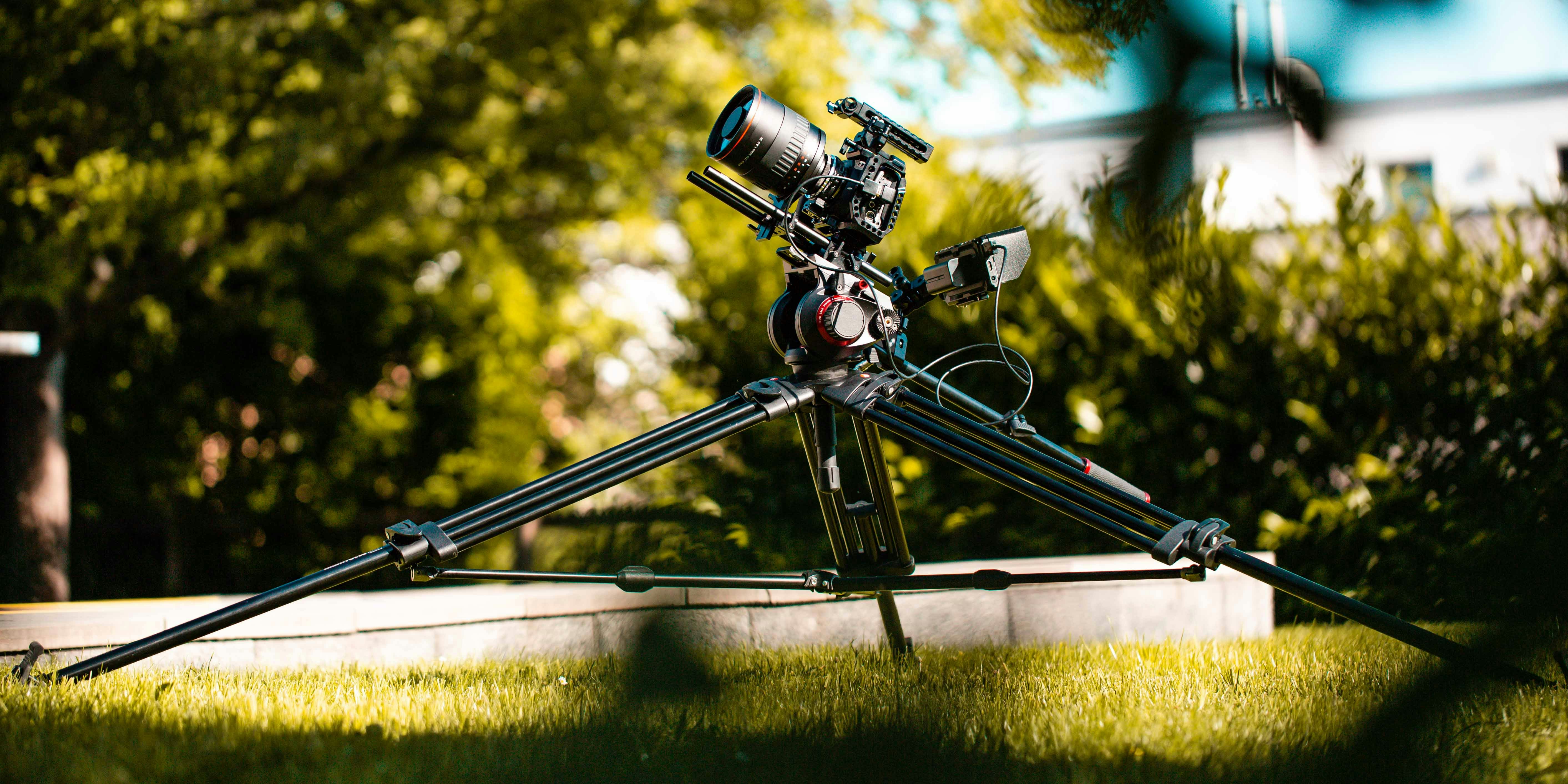 black dslr camera on tripod