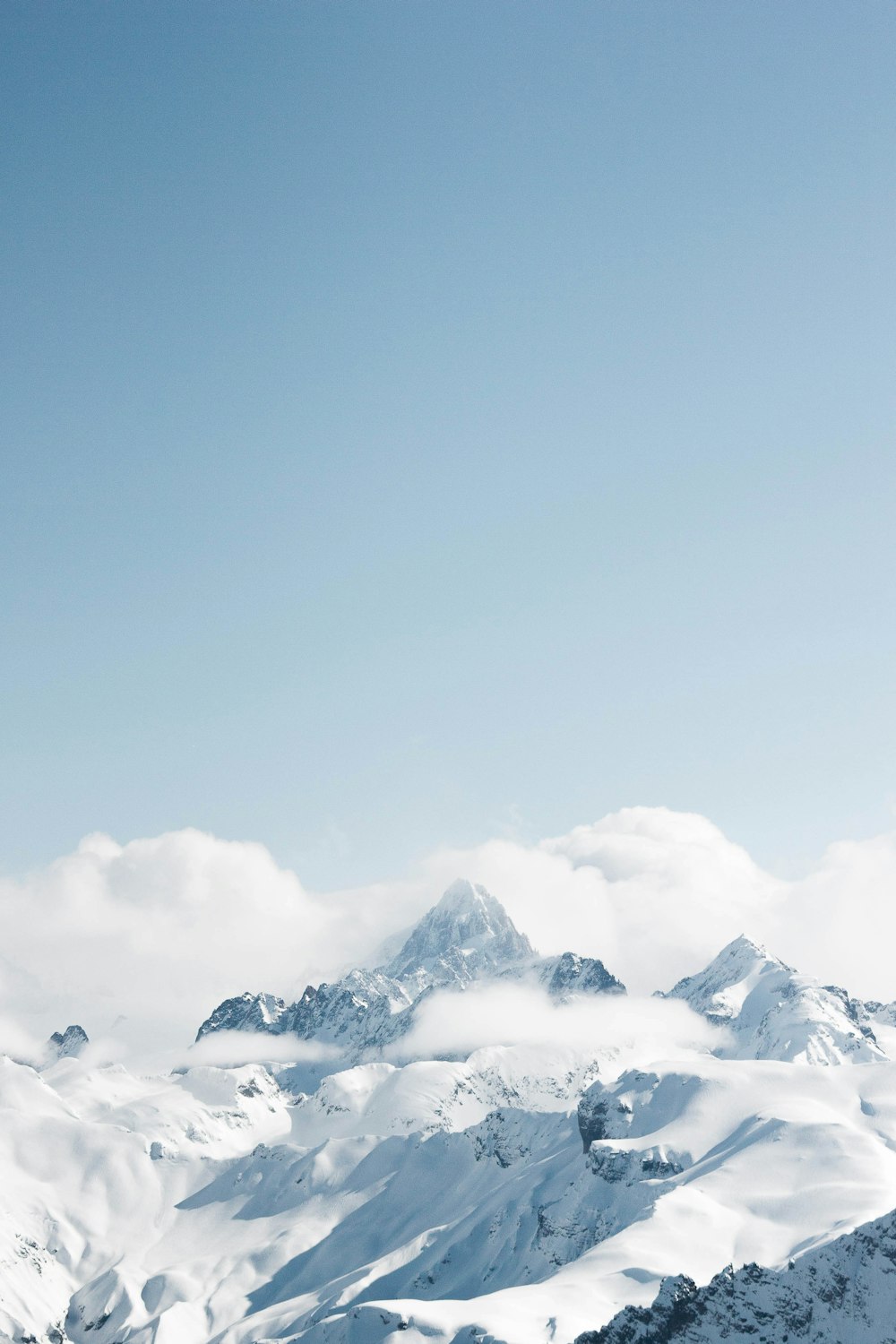 snow covered mountain under blue sky during daytime