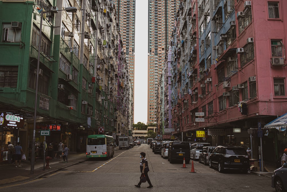 people walking on street between high rise buildings during daytime