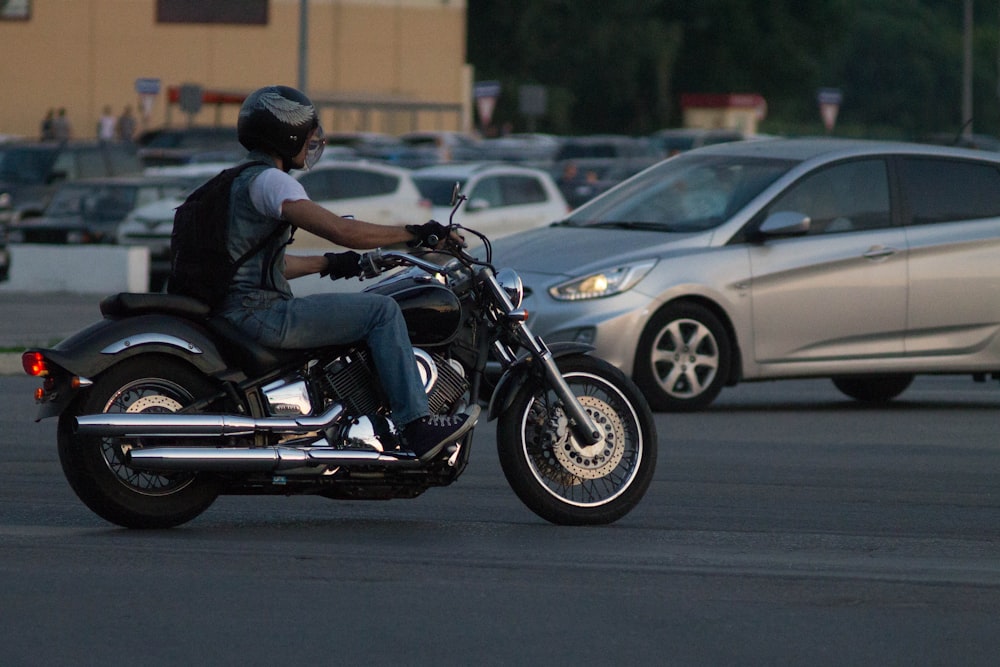 man in black jacket riding on black motorcycle during daytime