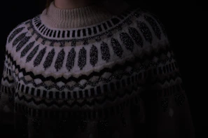 Close-up of a cozy, hand-knitted pet sweater with bright patterns.